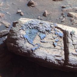 PIA12971: Rock with Odd Coating Beside a Young Martian Crater, False Color