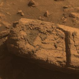 PIA12972: Rock with Odd Coating Beside a Young Martian Crater